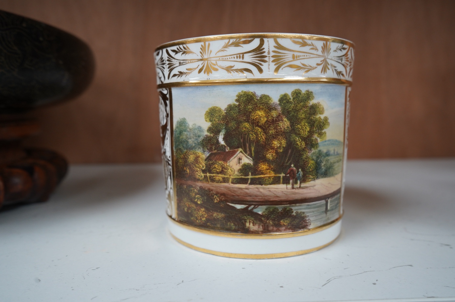 A Bloor Derby ‘Porter’ mug, c.1800-10, painted with a country scene, in the manner of Daniel Lucas, 11cm high. Condition - crack to base internally